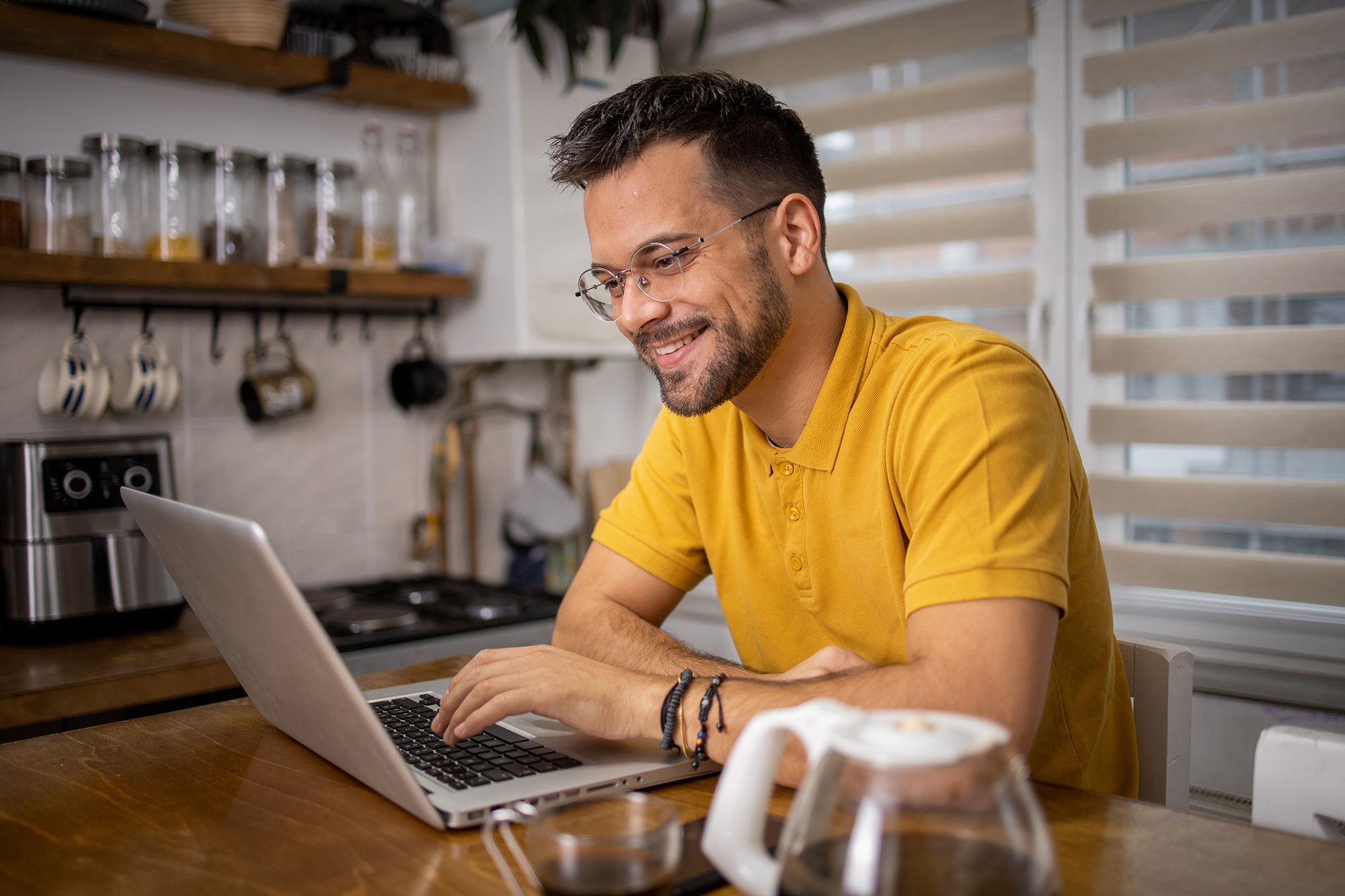man sitting at laptop in his home
