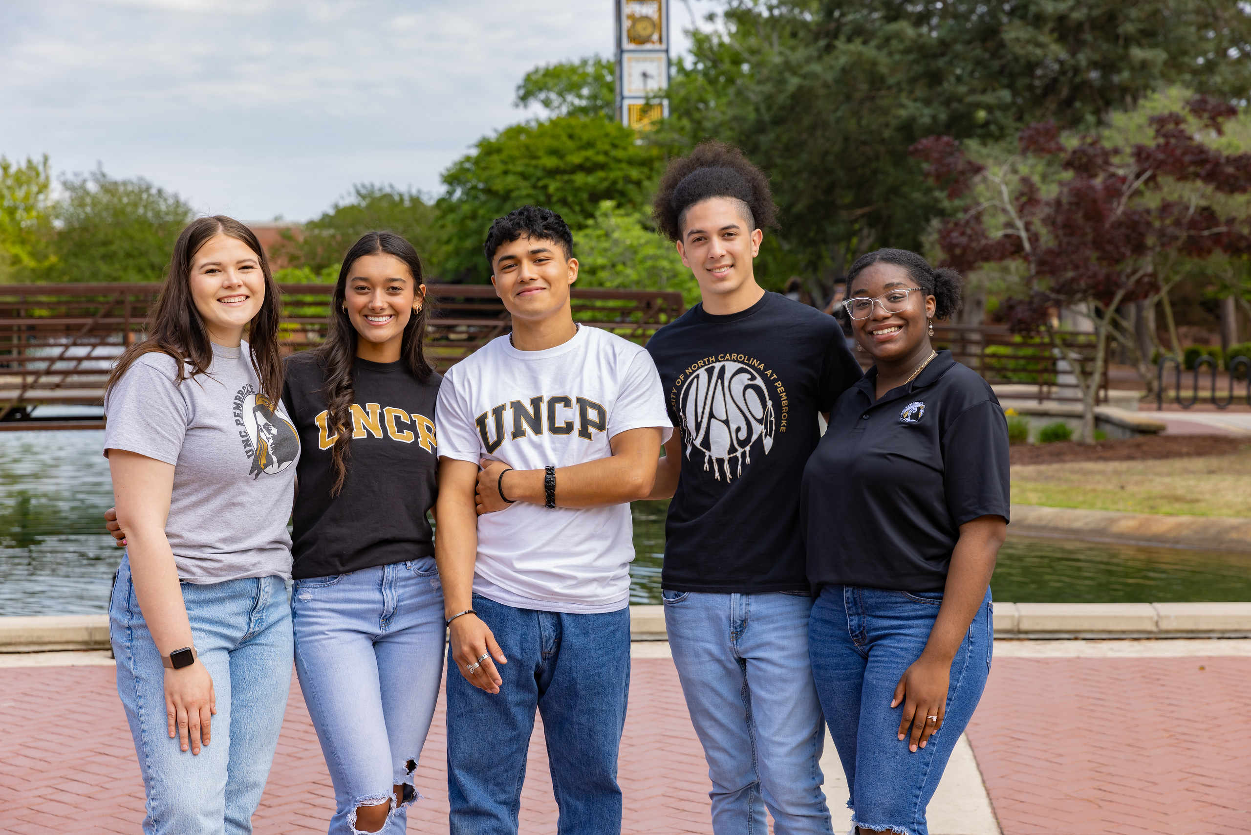 students on UNCP campus in front of bell tower