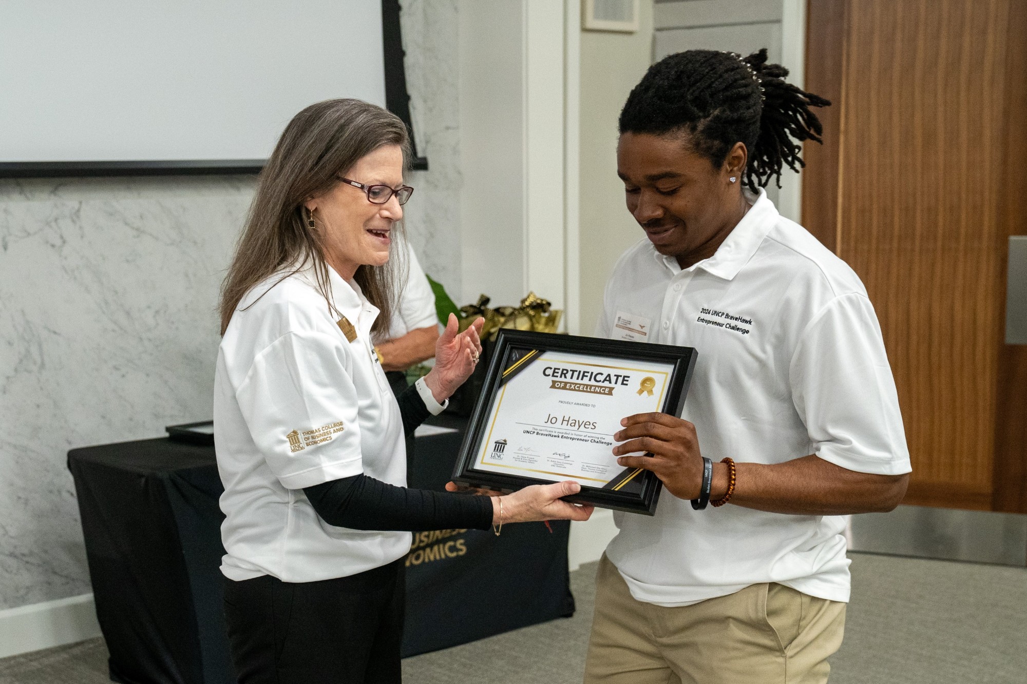 UNCP Provost Diane Prusank hands a student a certificate