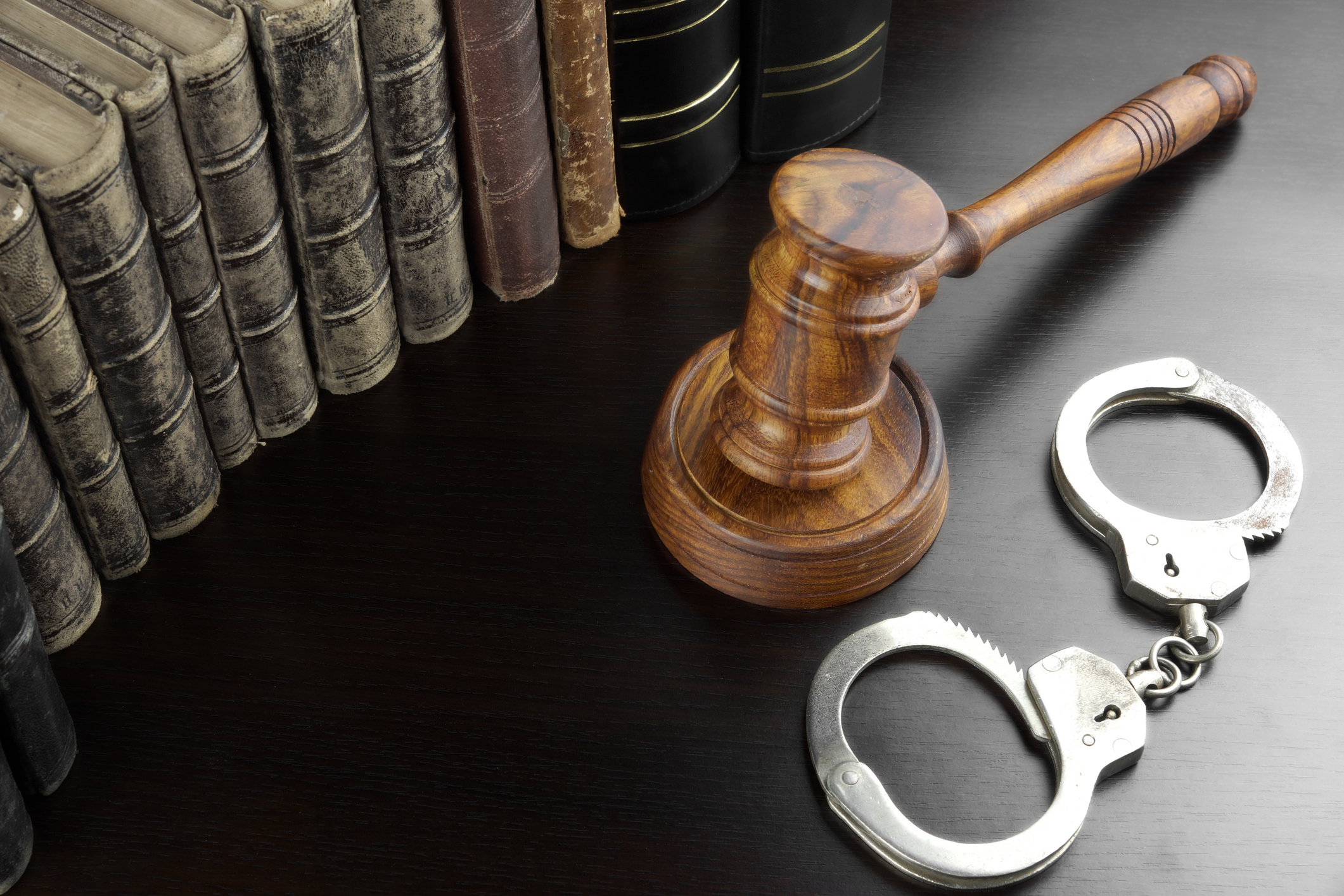 handcuffs with books and gavel