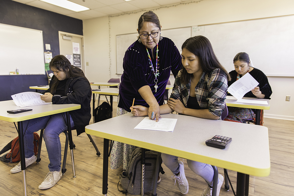 female teacher shows student how to do a math equation