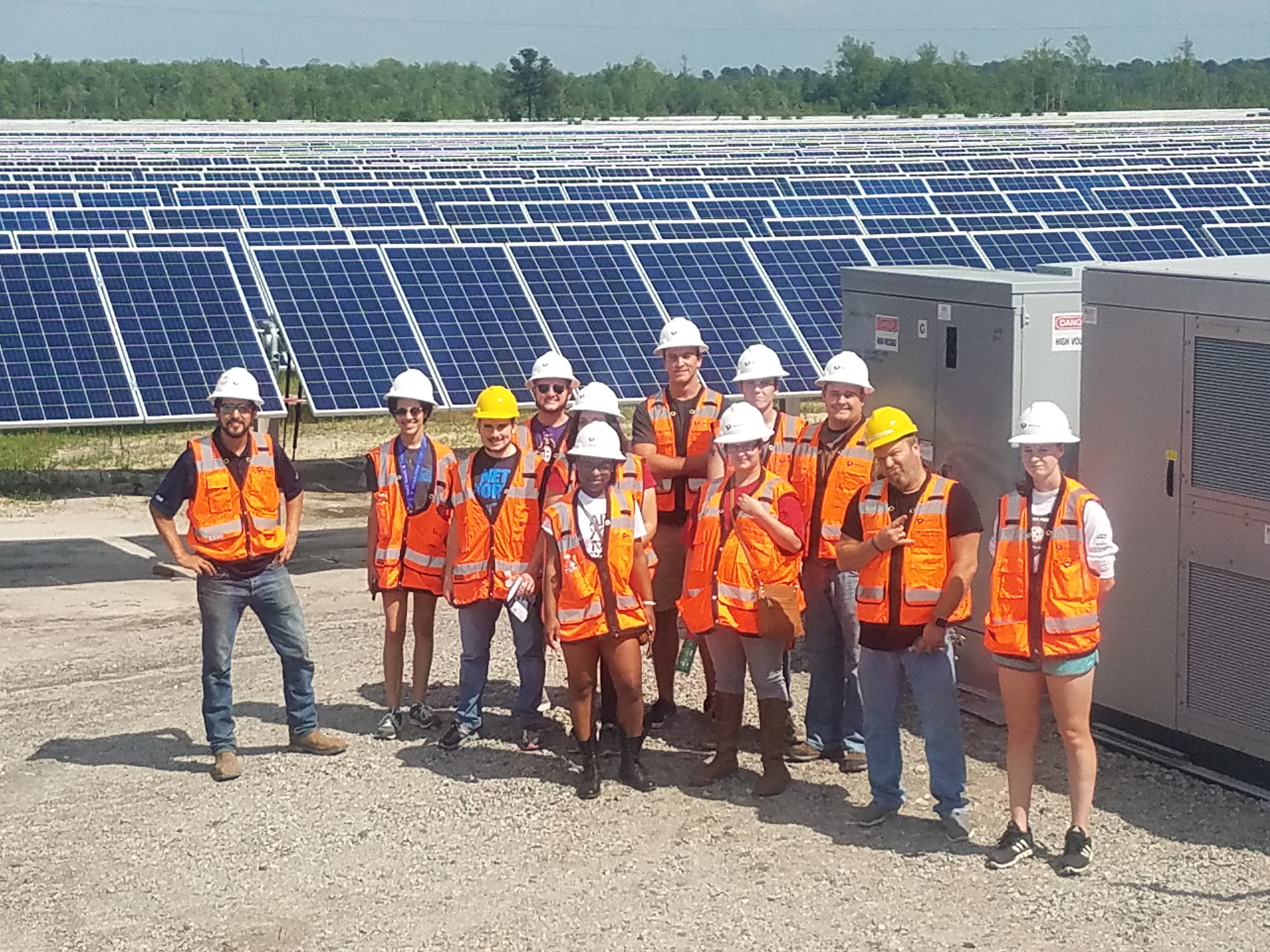 UNCP students in orange vests touring a solar farm.