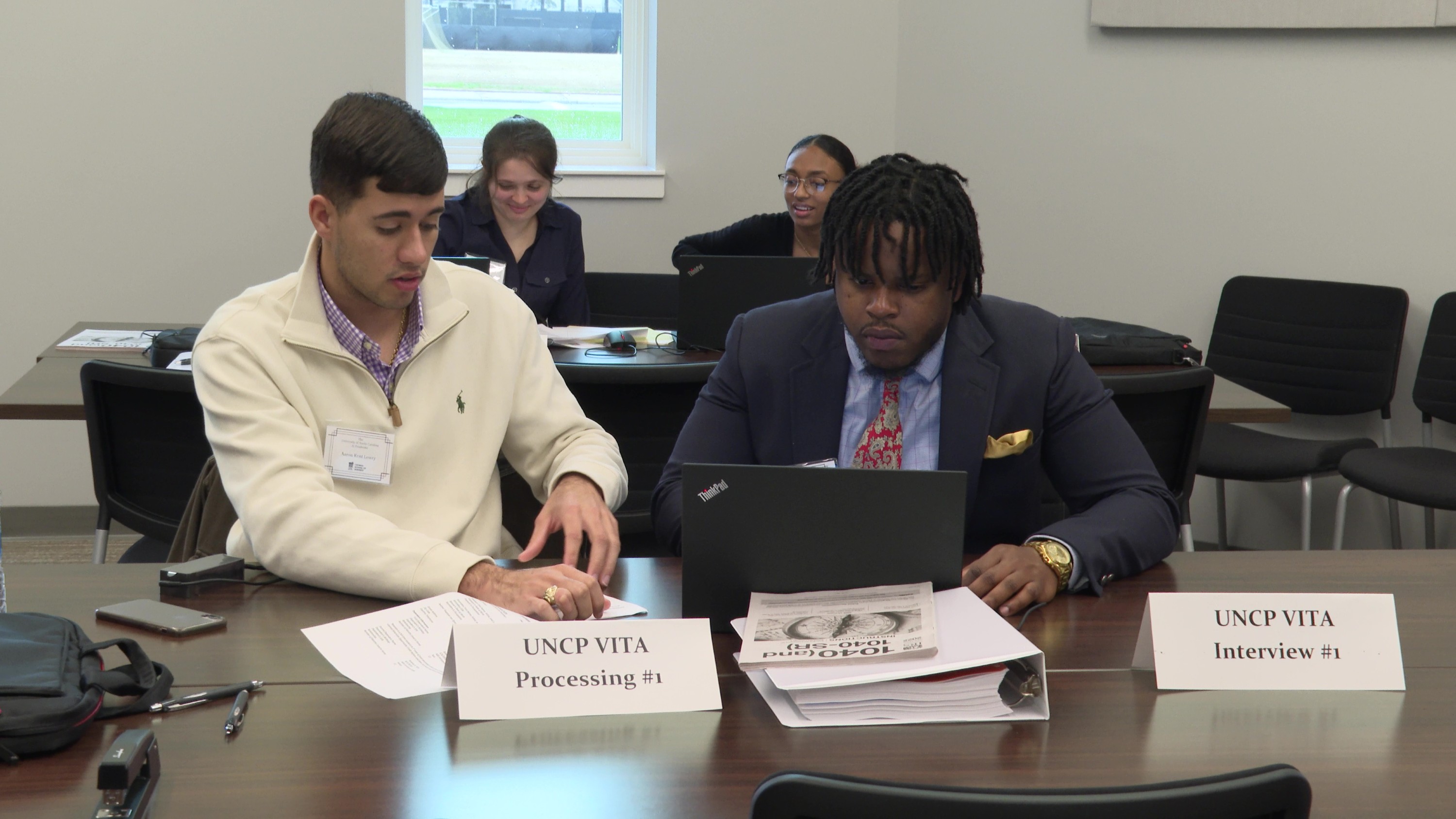 Student working with a community member on taxes