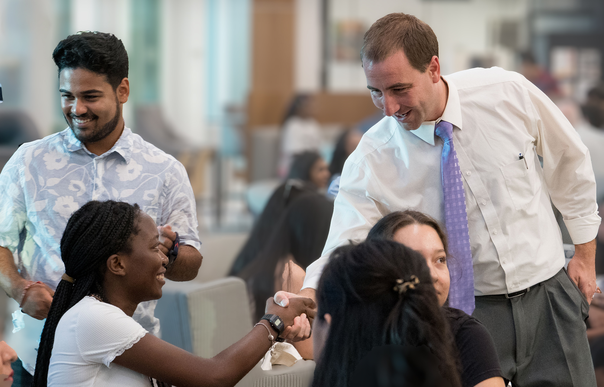 UNCP Staff Senate Chair M. Gordon Byrd shaking student's hand