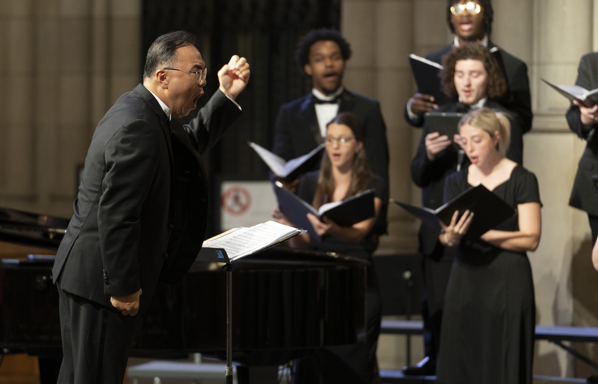musical director leading chorus at UNCP
