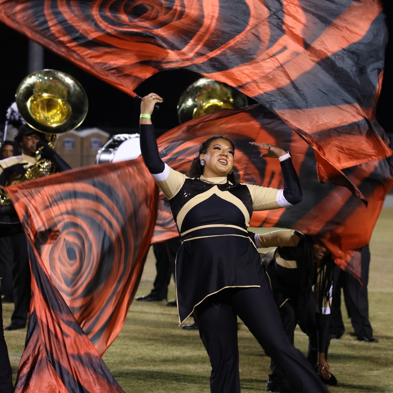 female member of marchng band colorguard waving flag at UNCP