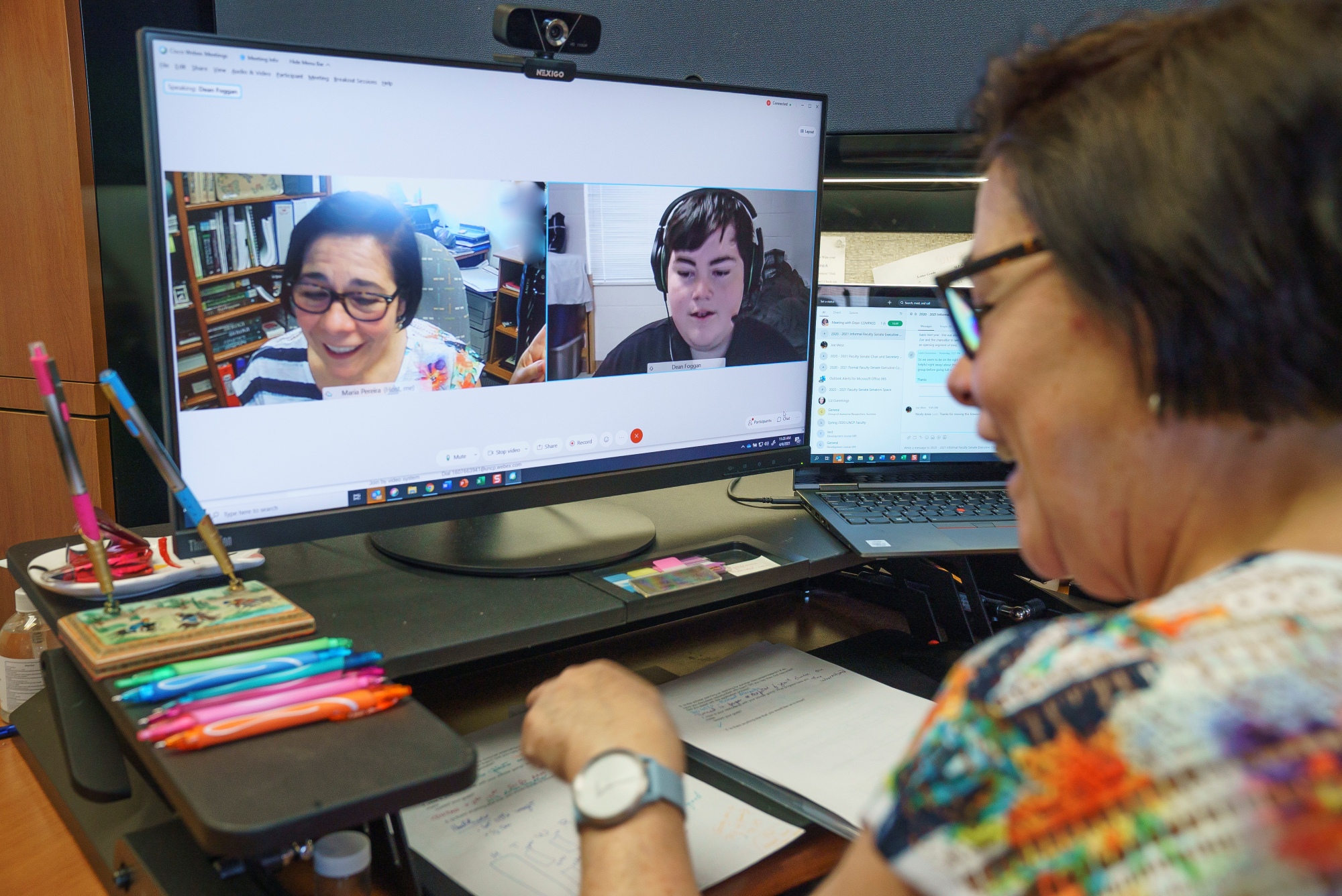 Professor teleconferencing with a student for advising.