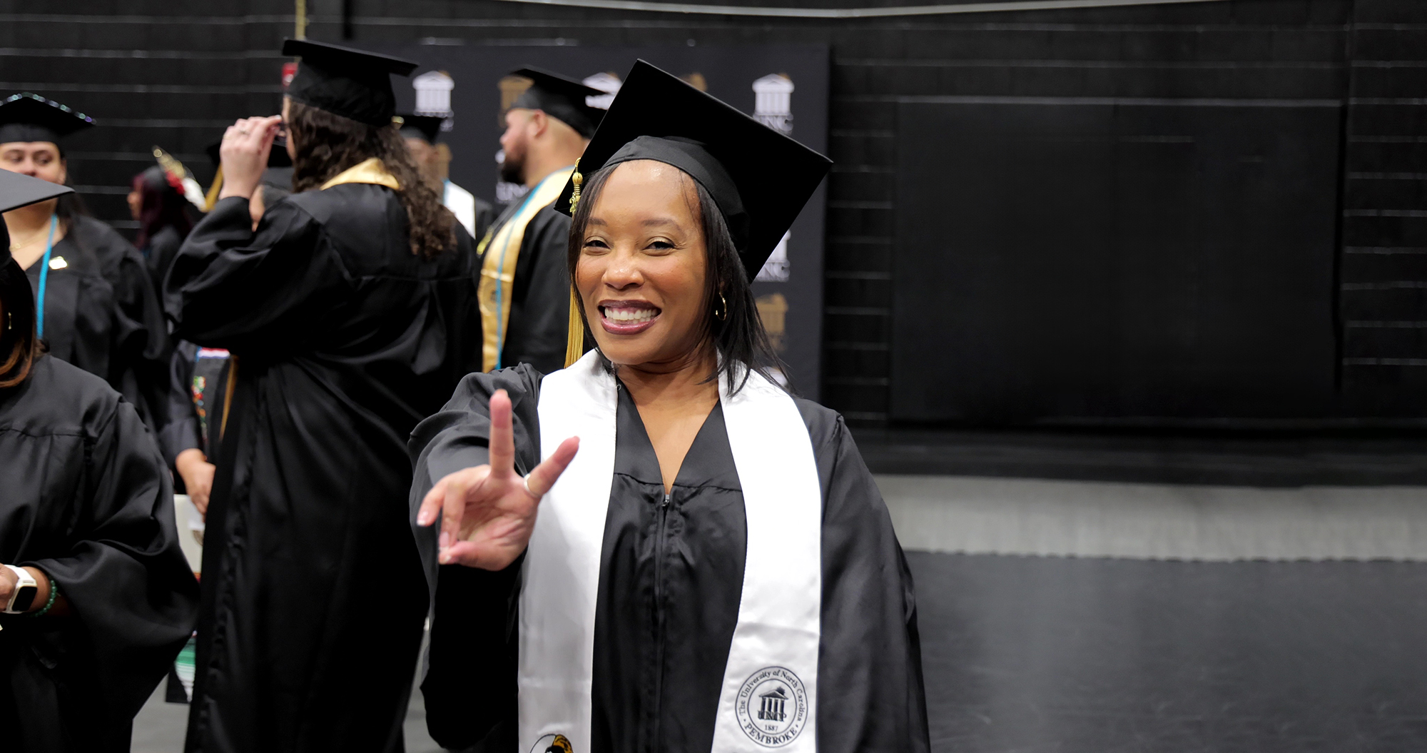 UNCP Graduate Marquitta Harrington in her cap and gown at commencement