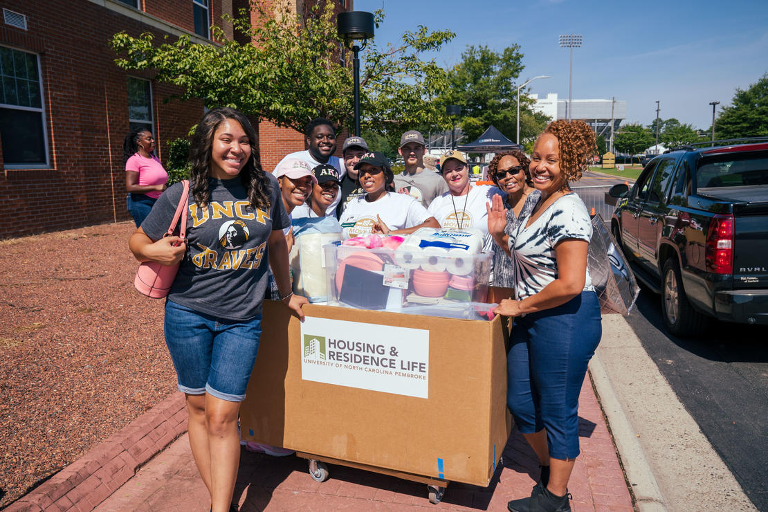 A picture of students helping to move in a new Brave on Freshman Move In Day