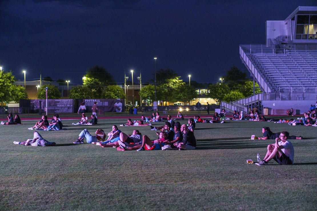 A picture of students watching a movie on the Grace P. Johnson football field