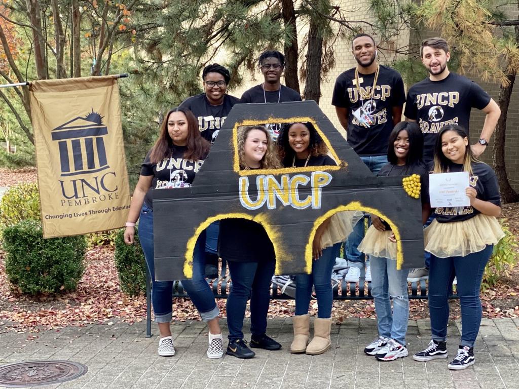 UNC Pembroke won a first-place Roll Call Spirit Award at North Carolina Housing Officers’ Resident Advisor Drive-In Conference. Back row: Jayla Coley (left) Jakael Bennett, Zyreke Ward, Zack Busicnki. Front row: Sterlyn Dominguez (left) Kendra Buck, Brea Brown, Shchiah Cook, Samantha Torres