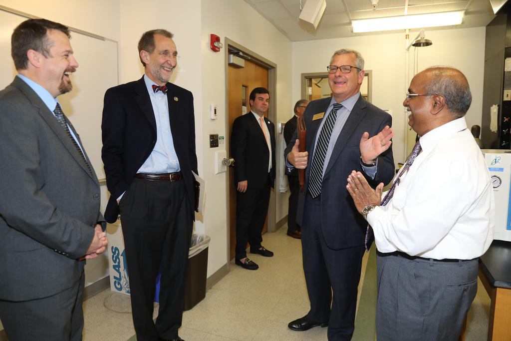 UNC System Interim President Bill Roper chats with Dean Todd Telemeco (far right), Provost David Ward and Professor Siva Mandjiny