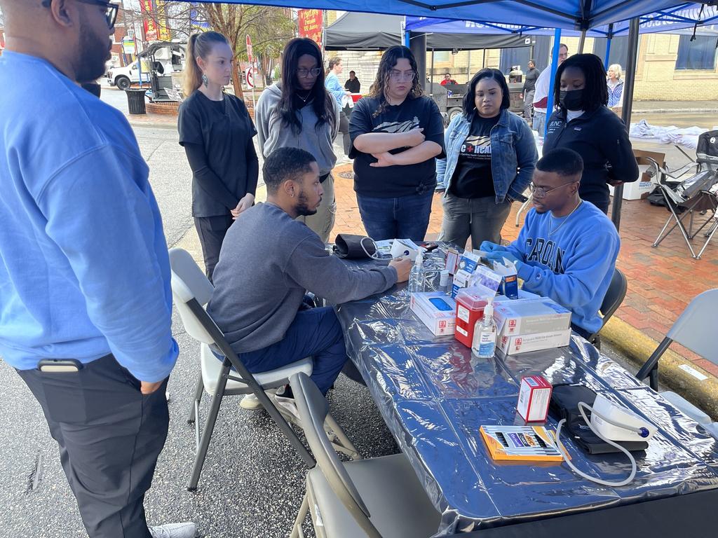 NC-HCAP students and UNC Chapel Hill School of Medicine MED Excel Team served 78 people and 21 community surveys were completed at the Rumba on the Lumber.