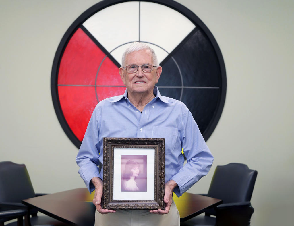 Willie Osbourne holds a framed portrait of his late wife, Eileen Oxendine Osbourne, after establishing the Willie & Eileen Oxendine Osbourne Endowed Nursing Scholarship at UNCP