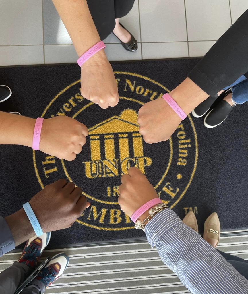 Healthy Start Connection staff show off bracelets in support of Infant Mortality Awareness which is celebrated in September