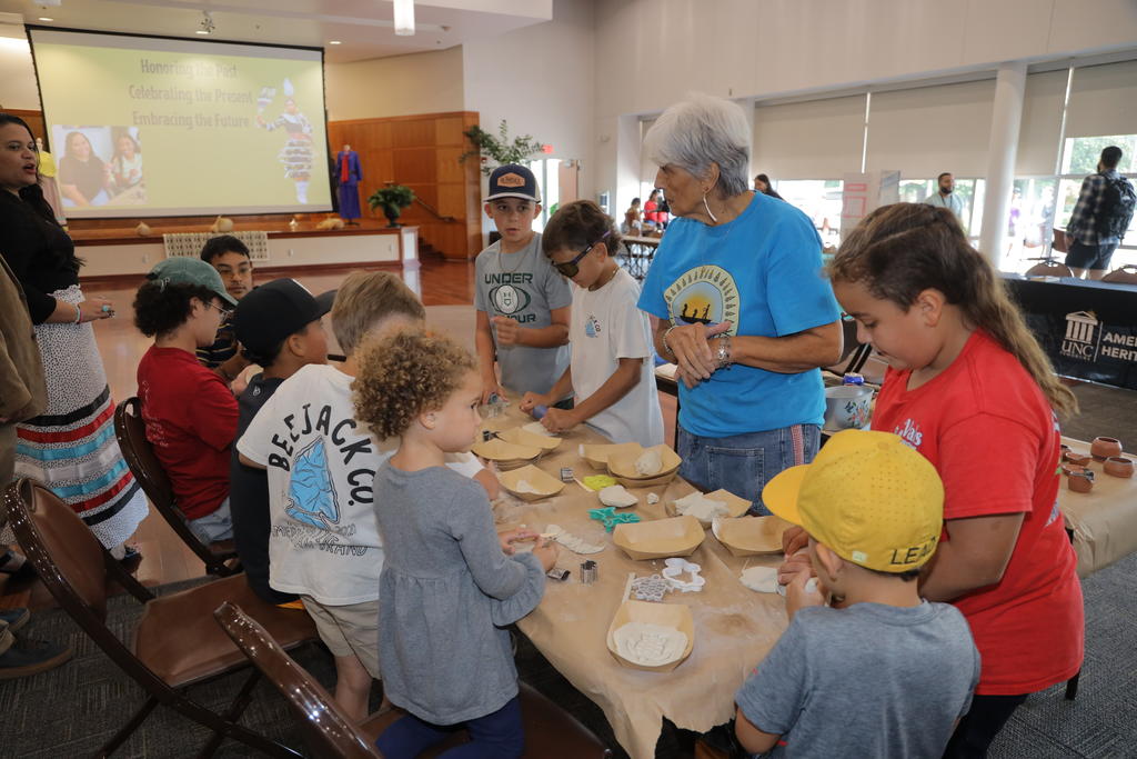 Local artist Phyllis Lowery gives a clay demonstration at the Indigenous Peoples' Day event at UNC Pembroke