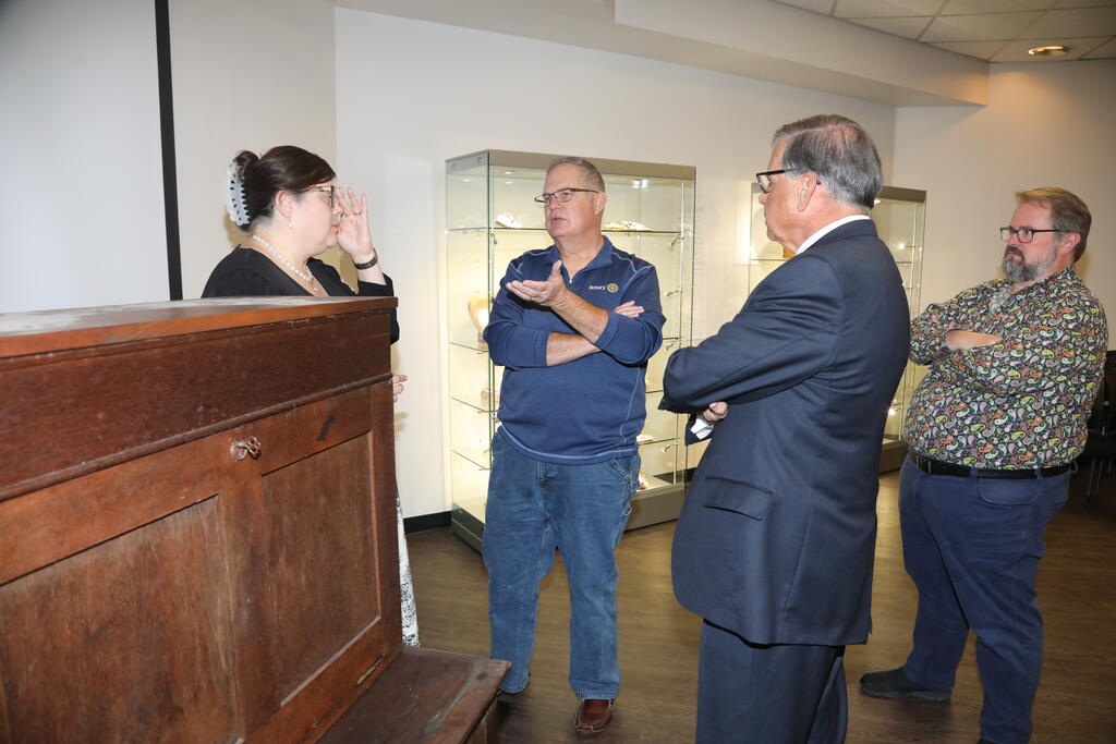 Johnny Robertson (center) helped facilitate the relocation of the desk to the Museum of the Southeast American Indian