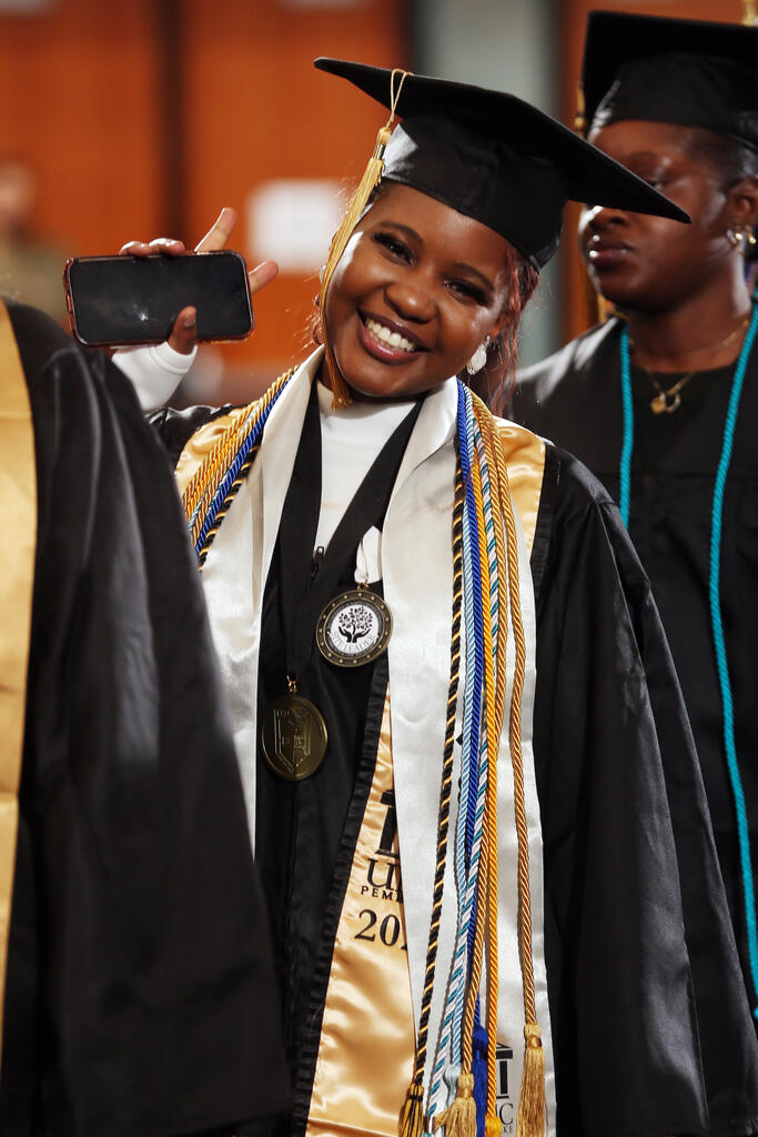 Anesu Mavhiya shows off her diploma at UNC Pembroke's Winter Commencement on December 14, 2025