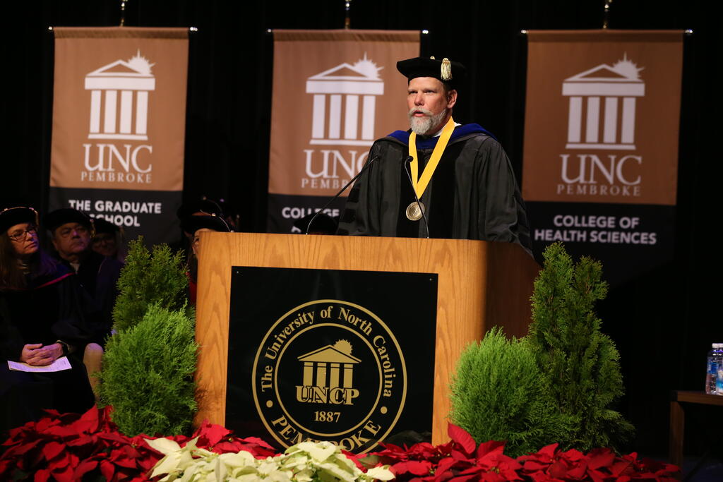 Professor Ryan Anderson, PhD, delivers keynote remarks at The Graduate School ceremony on December 13, 2024