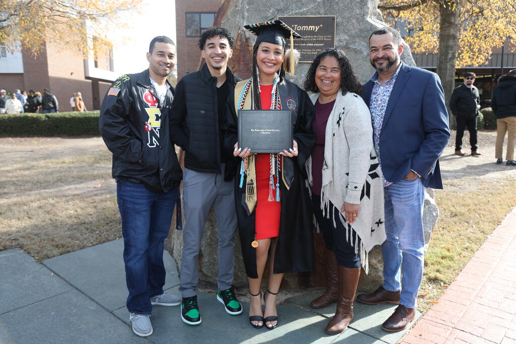 UNCP alumna Kaloni Walton of Lumberton celebrates with her family after Saturday's graduation ceremony