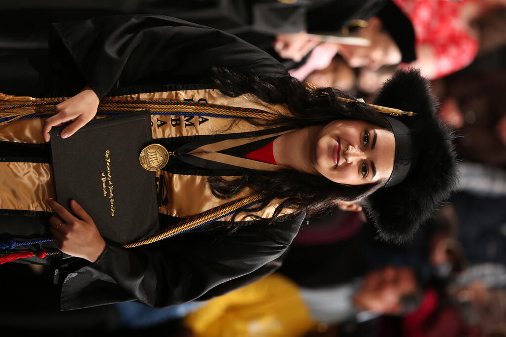 Dina Abumohsen pauses for a photo during the 2024 Winter Commencement at the English E. Jones Center