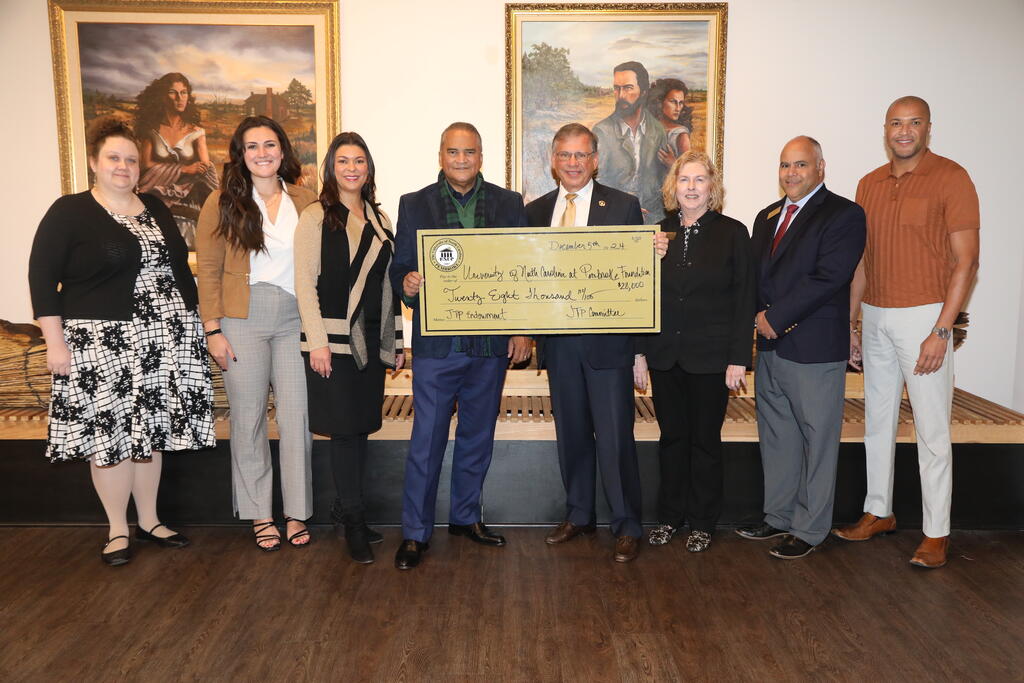 Devin Trego, far left, Eleni Garbrandt, Dr. Rebekah Lowry, Harvey Godwin Jr., Chancellor Robin Gary Cummings, M.D., Anita Stallings, Kelvin Jacobs and Patrick Strickland