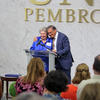Vivian R. Jacobson and Chancellor Robin G. Cummings hug in front of a large crowd gathered at UNC Pembroke.